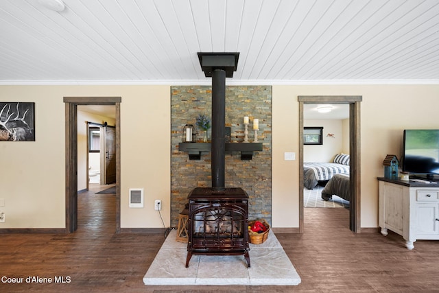 215 Gordon Dr, Priest Lake, ID 83856 - living room with a wood stove, crown molding, wood finished floors, and wooden ceiling