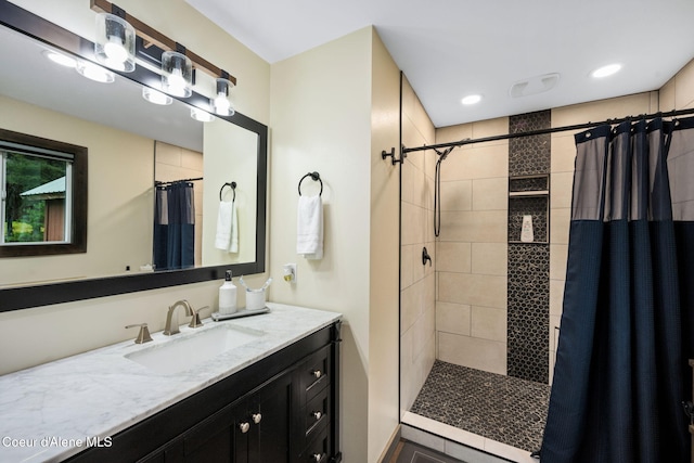 215 Gordon Dr, Priest Lake, ID 83856 - bathroom with tiled shower, vanity, and recessed lighting