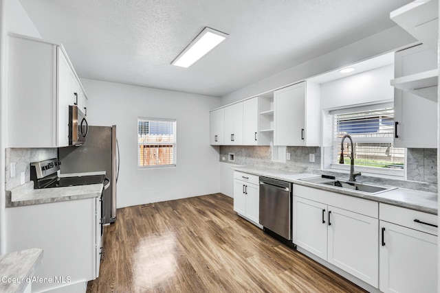 4204 N Jefferson St, Spokane, WA 99205 - kitchen featuring open shelves, stainless steel appliances, tasteful backsplash, and white cabinetry