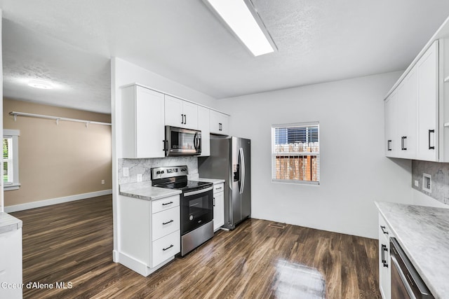 4204 N Jefferson St, Spokane, WA 99205 - kitchen featuring appliances with stainless steel finishes, dark wood-style floors, decorative backsplash, light countertops, and a textured ceiling
