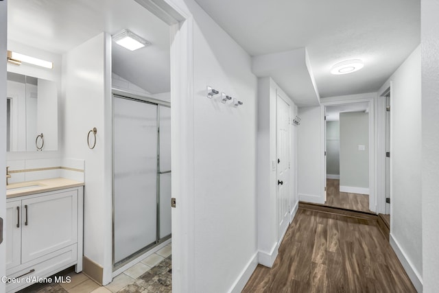 4204 N Jefferson St, Spokane, WA 99205 - full bathroom with vanity, a stall shower, wood finished floors, and vaulted ceiling