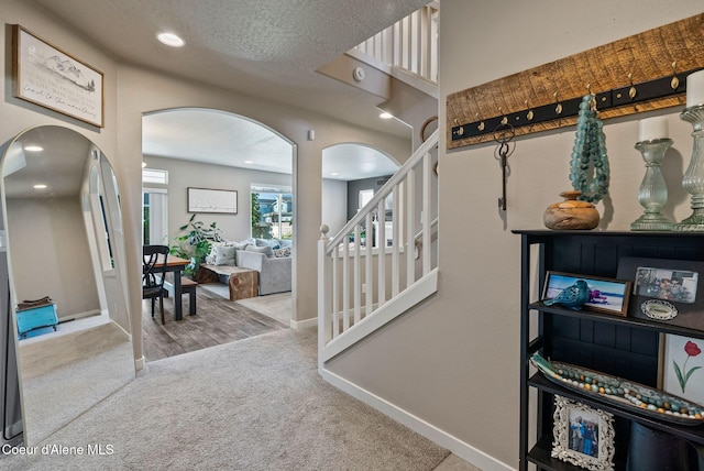 4483 N Connery Loop, Post Falls, ID 83854 - carpeted entryway featuring arched walkways, stairway, and recessed lighting