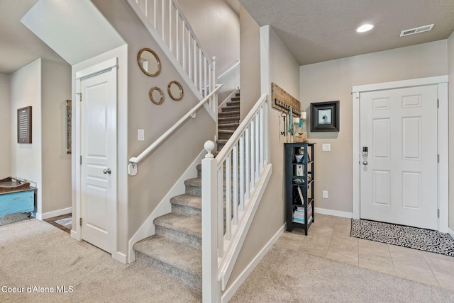 4483 N Connery Loop, Post Falls, ID 83854 - carpeted foyer with stairs and recessed lighting