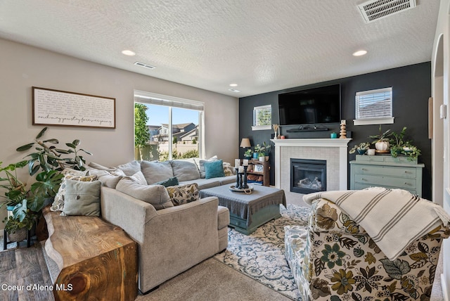 4483 N Connery Loop, Post Falls, ID 83854 - living area with a textured ceiling, recessed lighting, and a tile fireplace