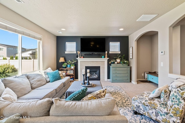 4483 N Connery Loop, Post Falls, ID 83854 - living area with healthy amount of natural light, arched walkways, carpet, a textured ceiling, and recessed lighting