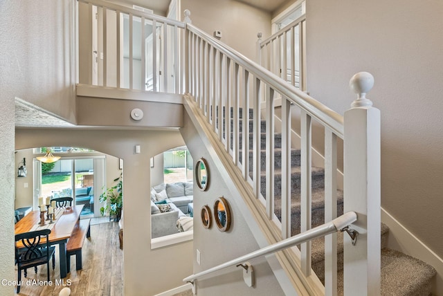 4483 N Connery Loop, Post Falls, ID 83854 - stairs featuring wood finished floors, a high ceiling, and arched walkways