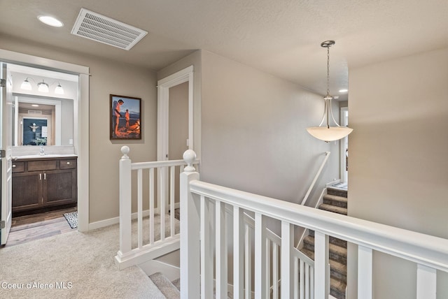4483 N Connery Loop, Post Falls, ID 83854 - hall with light colored carpet, recessed lighting, and an upstairs landing