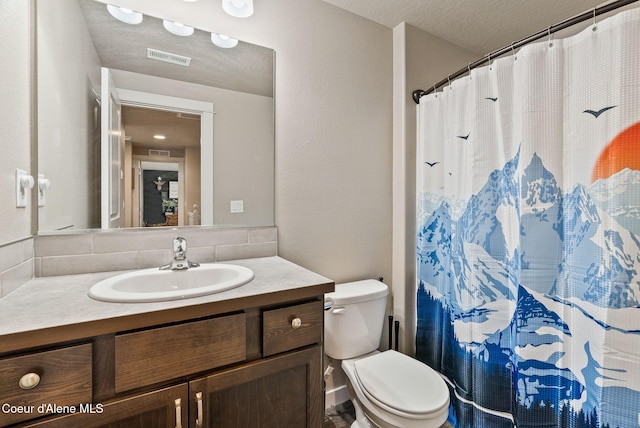 4483 N Connery Loop, Post Falls, ID 83854 - bathroom featuring vanity, decorative backsplash, a textured ceiling, and a shower with shower curtain