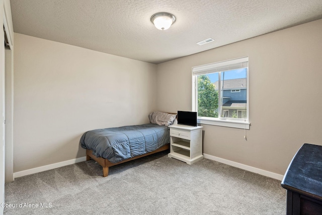 4483 N Connery Loop, Post Falls, ID 83854 - carpeted bedroom featuring baseboards and a textured ceiling