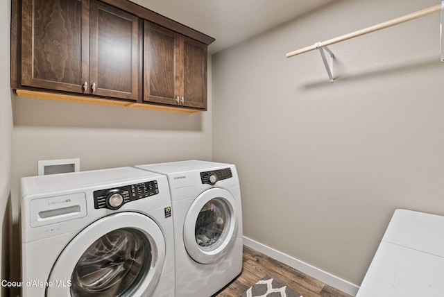 4483 N Connery Loop, Post Falls, ID 83854 - laundry room with cabinet space, separate washer and dryer, and wood finished floors