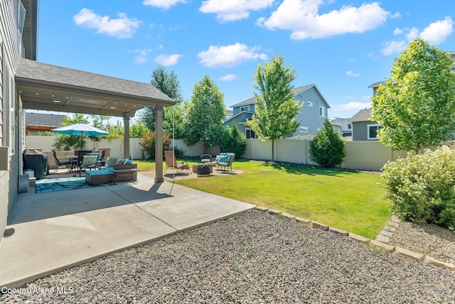4483 N Connery Loop, Post Falls, ID 83854 - fenced backyard with an outdoor fire pit and a patio area