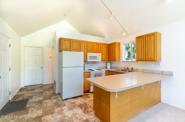 2015 N 13th St, Coeur Dalene, ID 83814 - kitchen with white appliances, light countertops, vaulted ceiling, a peninsula, and rail lighting