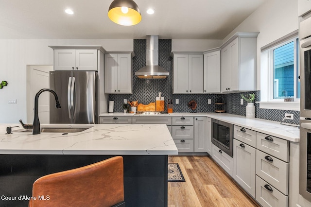 2119 E Lakeside Ave, Coeur Dalene, ID 83814 - kitchen with wall chimney range hood, appliances with stainless steel finishes, gray cabinetry, and light stone counters