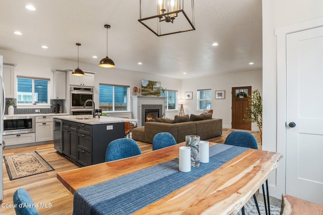 2119 E Lakeside Ave, Coeur Dalene, ID 83814 - dining room with light wood-type flooring, recessed lighting, and a glass covered fireplace