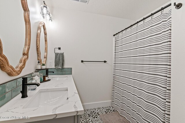 2119 E Lakeside Ave, Coeur Dalene, ID 83814 - bathroom featuring double vanity, a shower with curtain, and tile patterned floors
