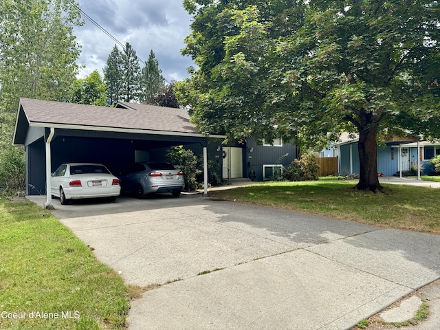 1816-1818 N Burl Ln, Coeur Dalene, ID 83814 - view of front of home with a carport, driveway, a front yard, and roof with shingles