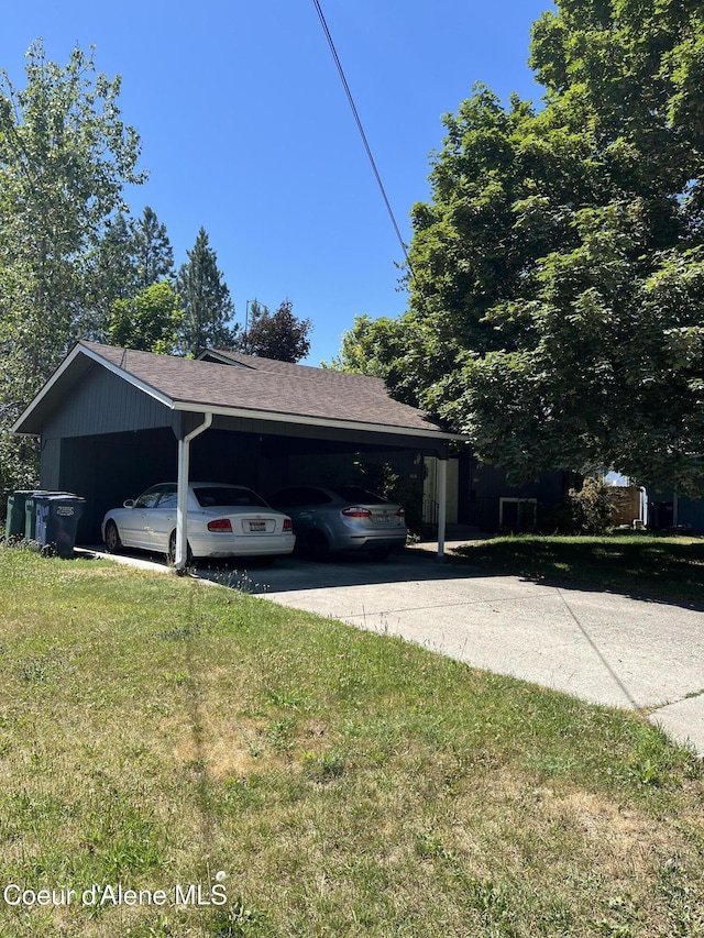 1816-1818 N Burl Ln, Coeur Dalene, ID 83814 - view of home's exterior with driveway, a yard, roof with shingles, and a carport