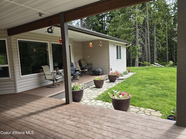 12671 E Trout Pond Rd, Athol, ID 83801 - wooden deck featuring a lawn