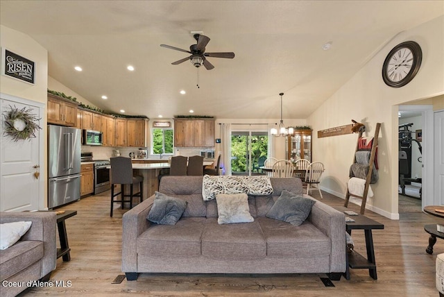 12671 E Trout Pond Rd, Athol, ID 83801 - living room with ceiling fan, recessed lighting, a chandelier, light wood-style flooring, and high vaulted ceiling