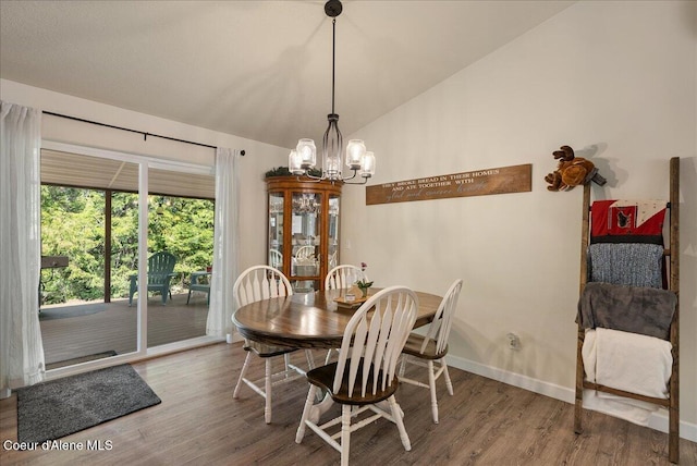 12671 E Trout Pond Rd, Athol, ID 83801 - dining space with lofted ceiling, wood finished floors, and a chandelier