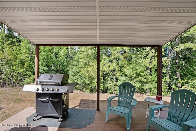 12671 E Trout Pond Rd, Athol, ID 83801 - wooden deck with grilling area and a wooded view