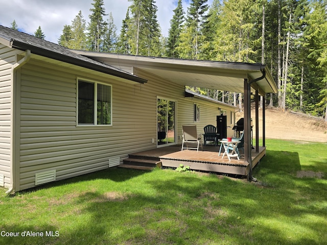 12671 E Trout Pond Rd, Athol, ID 83801 - rear view of property with a deck and a lawn