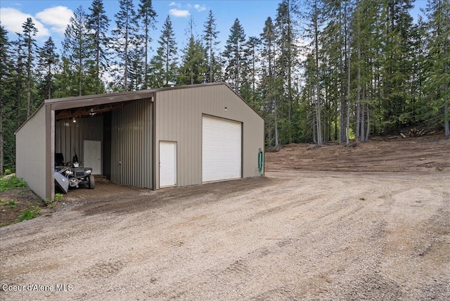 12671 E Trout Pond Rd, Athol, ID 83801 - garage featuring a garage and dirt driveway