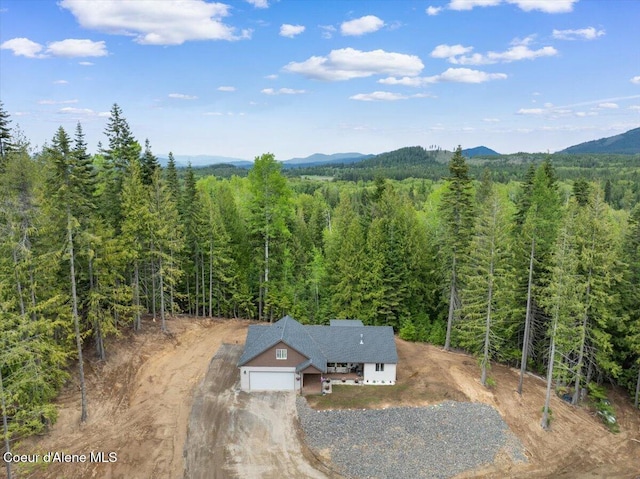 12671 E Trout Pond Rd, Athol, ID 83801 - view from above of property featuring a heavily wooded area and a mountain backdrop