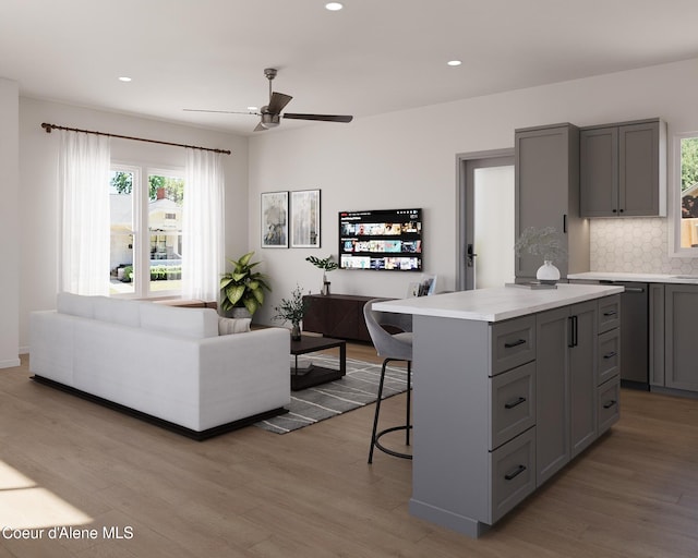 349 Jasper Loop, Ponderay, ID 83852 - kitchen featuring gray cabinets, a kitchen breakfast bar, light wood-type flooring, and recessed lighting