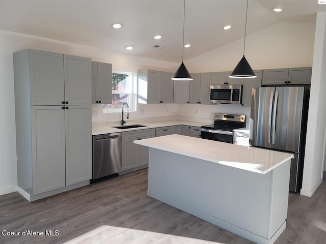 349 Jasper Loop, Ponderay, ID 83852 - kitchen with appliances with stainless steel finishes, light countertops, vaulted ceiling, a center island, and wood finished floors