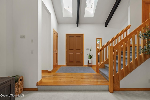 23388 N Teddy Loop, Rathdrum, ID 83858 - entryway with a skylight, beam ceiling, stairs, and carpet flooring