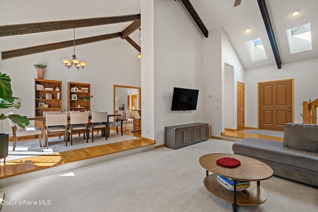 23388 N Teddy Loop, Rathdrum, ID 83858 - carpeted living room featuring high vaulted ceiling, beamed ceiling, a chandelier, a skylight, and recessed lighting