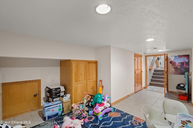 23388 N Teddy Loop, Rathdrum, ID 83858 - recreation room with light tile patterned floors and a textured ceiling