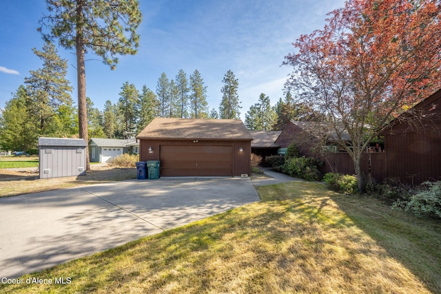 628 E Timber Ln, Coeur Dalene, ID 83815 - view of front of property featuring concrete driveway, a front lawn, and an attached garage