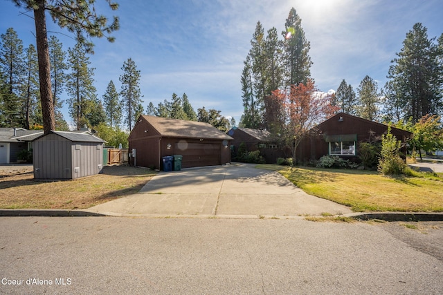628 E Timber Ln, Coeur Dalene, ID 83815 - view of front of property with a garage, a front lawn, concrete driveway, and a shed