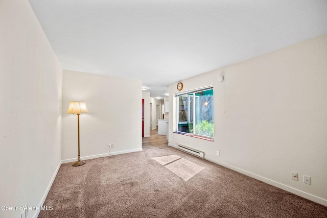628 E Timber Ln, Coeur Dalene, ID 83815 - spare room featuring a baseboard heating unit and light carpet