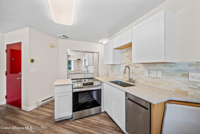 628 E Timber Ln, Coeur Dalene, ID 83815 - kitchen with appliances with stainless steel finishes, baseboard heating, and white cabinets
