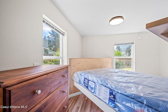 628 E Timber Ln, Coeur Dalene, ID 83815 - bedroom featuring wood finished floors and a textured wall