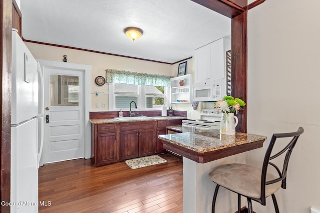 105 E Miller Ave, Coeur Dalene, ID 83814 - kitchen featuring white appliances, a breakfast bar, a peninsula, wood-type flooring, and open shelves