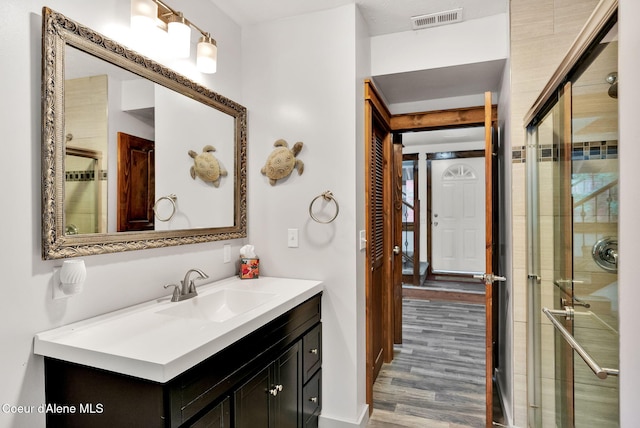 30553 N Stampede Rd, Athol, ID 83801 - bathroom featuring vanity, wood finished floors, and a tile shower