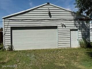 407 Hope St, Kootenai, ID 83840 - view of home's exterior with an outbuilding, a detached garage, and a yard