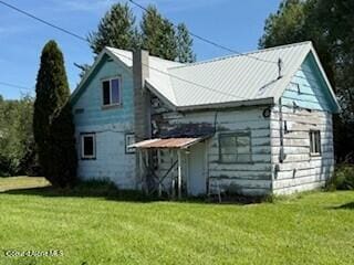 407 Hope St, Kootenai, ID 83840 - back of house with a lawn and a chimney