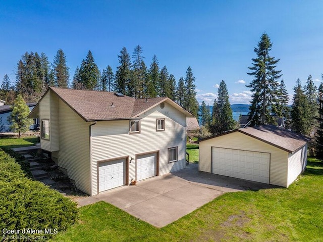 9218 W Rockford Bay Rd, Coeur Dalene, ID 83814 - view of side of property featuring a lawn, an outdoor structure, and a garage