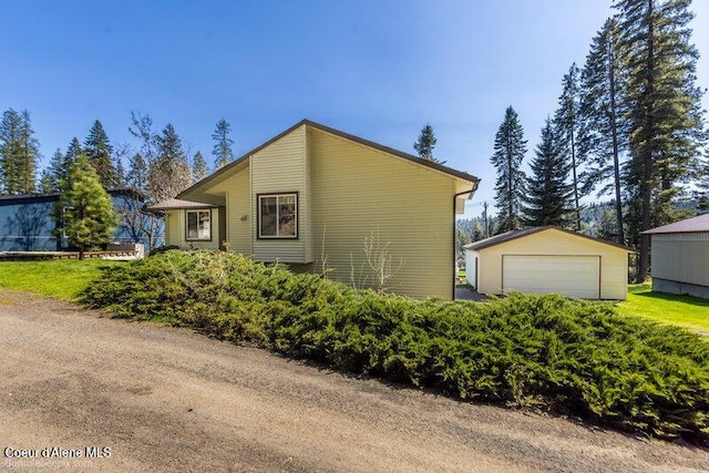 9218 W Rockford Bay Rd, Coeur Dalene, ID 83814 - view of side of home with an outbuilding and a detached garage