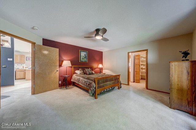 9218 W Rockford Bay Rd, Coeur Dalene, ID 83814 - bedroom with connected bathroom, light carpet, and a ceiling fan