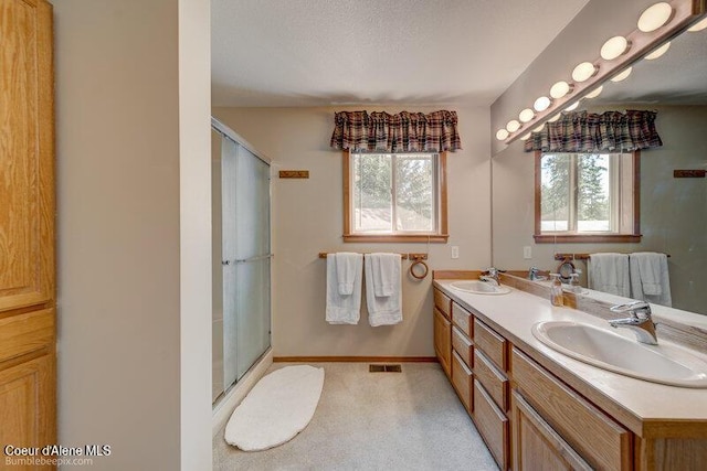 9218 W Rockford Bay Rd, Coeur Dalene, ID 83814 - bathroom featuring double vanity and a shower with door