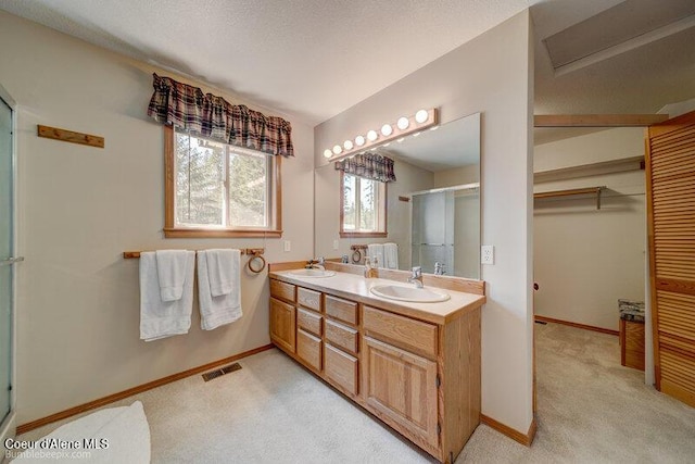 9218 W Rockford Bay Rd, Coeur Dalene, ID 83814 - bathroom featuring a stall shower, double vanity, and a spacious closet