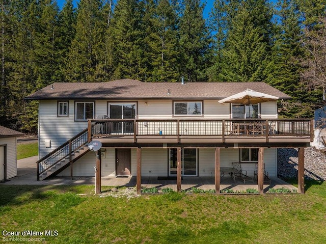9218 W Rockford Bay Rd, Coeur Dalene, ID 83814 - rear view of property with a patio, stairway, a deck, and a lawn
