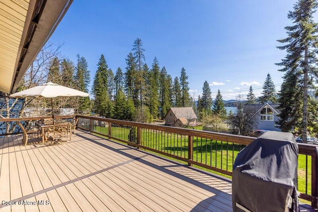 9218 W Rockford Bay Rd, Coeur Dalene, ID 83814 - wooden terrace featuring outdoor dining area, grilling area, and a lawn