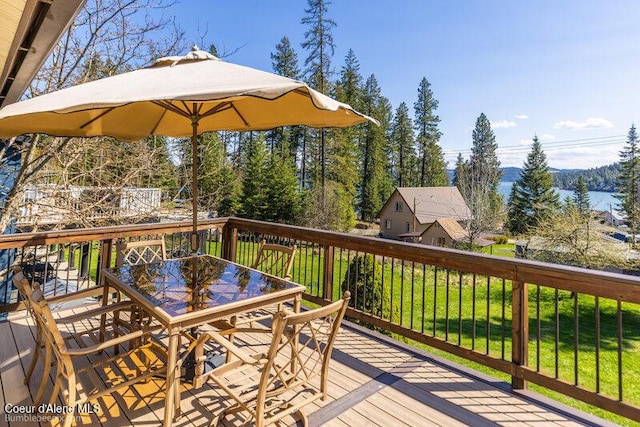 9218 W Rockford Bay Rd, Coeur Dalene, ID 83814 - deck featuring outdoor dining area and a lawn